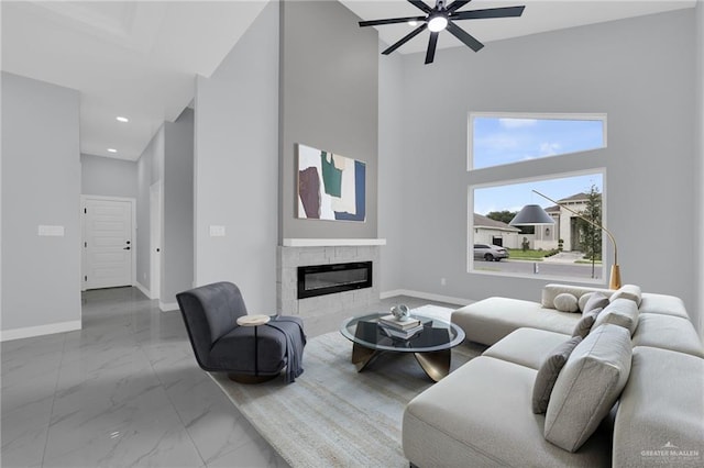 3107 S Auburndale Ave, Edinburg, TX 78542 - living area featuring ceiling fan, baseboards, marble finish flooring, a glass covered fireplace, and recessed lighting