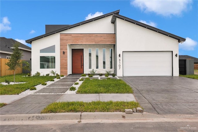 3107 S Auburndale Ave, Edinburg, TX 78542 - modern home with stucco siding, an attached garage, and decorative driveway
