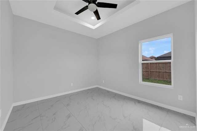3107 S Auburndale Ave, Edinburg, TX 78542 - unfurnished room with baseboards, a raised ceiling, marble finish flooring, ceiling fan, and recessed lighting