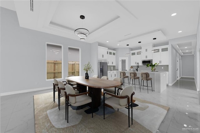3107 S Auburndale Ave, Edinburg, TX 78542 - dining room featuring light marble finish floors, a tray ceiling, baseboards, and recessed lighting