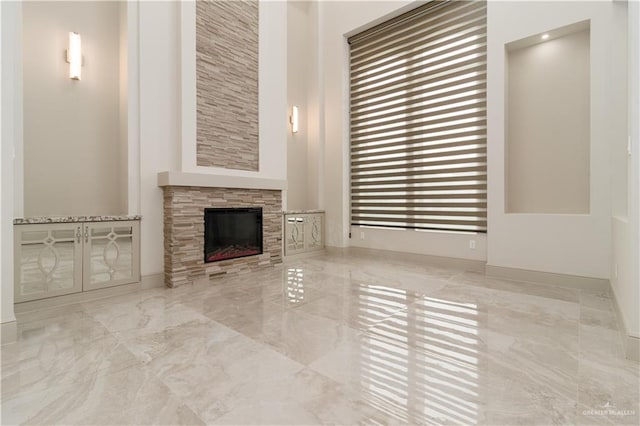 unfurnished living room featuring a fireplace