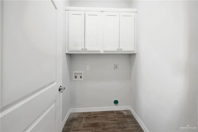 washroom featuring washer hookup, electric dryer hookup, dark hardwood / wood-style flooring, and cabinets