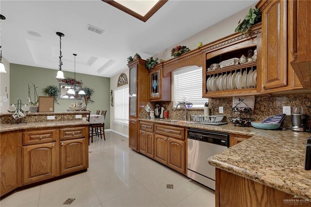 kitchen with a raised ceiling, dishwasher, visible vents, a sink, and brown cabinetry