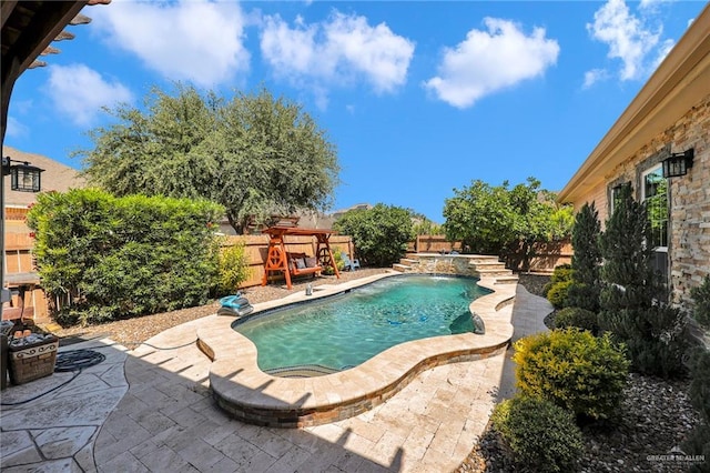 pool featuring a fenced backyard and a patio