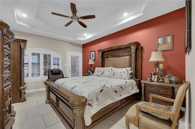 bedroom with light tile patterned floors, a ceiling fan, a tray ceiling, and recessed lighting