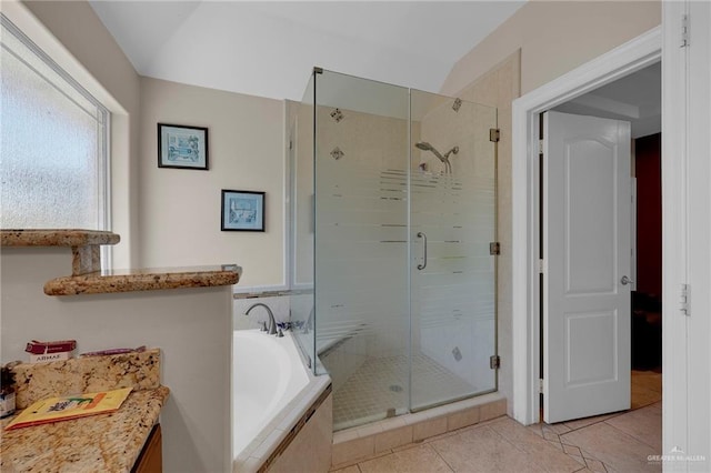 bathroom with a bath, tile patterned floors, and a stall shower