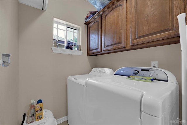 clothes washing area with cabinet space and washer and dryer