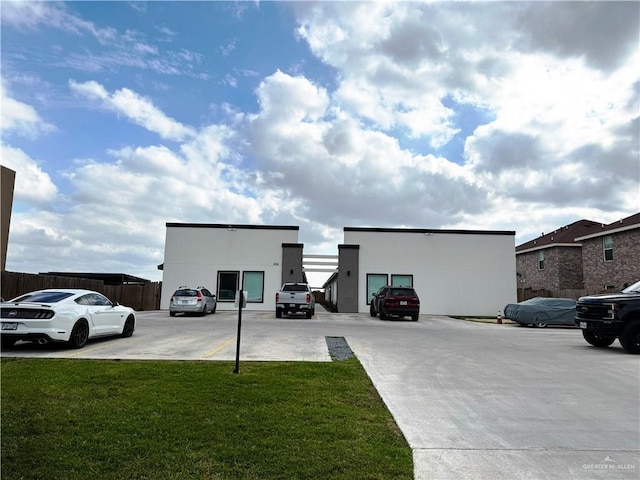 exterior space featuring uncovered parking and fence