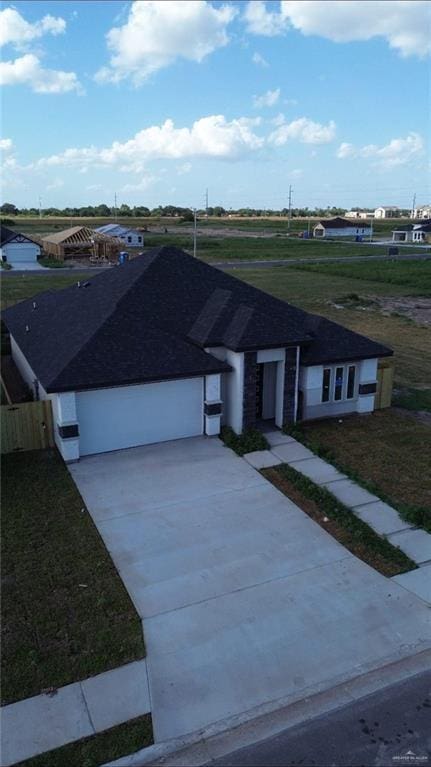 2108 Blue Sky Dr, Weslaco, TX 78599 - single story home featuring an attached garage, concrete driveway, and a front lawn