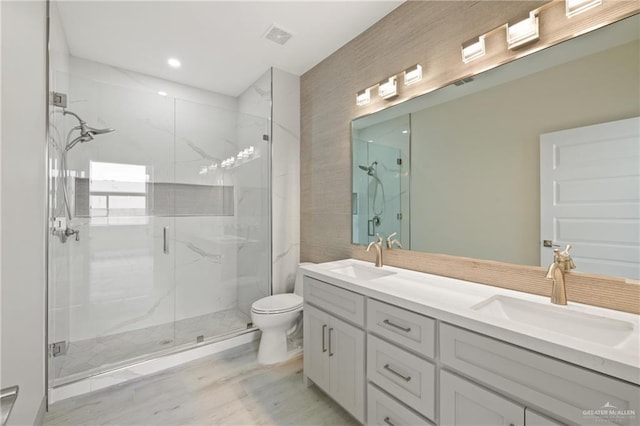 1220 N Lincoln Ave, San Juan, TX 78589 - bathroom with a marble finish shower, double vanity, toilet, and wood finished floors