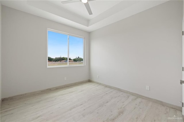 1220 N Lincoln Ave, San Juan, TX 78589 - unfurnished room featuring light wood finished floors, a ceiling fan, baseboards, and a raised ceiling