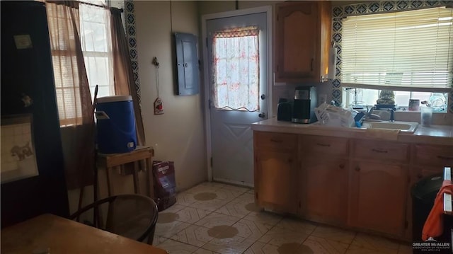 kitchen with light tile patterned floors, electric panel, and a wealth of natural light