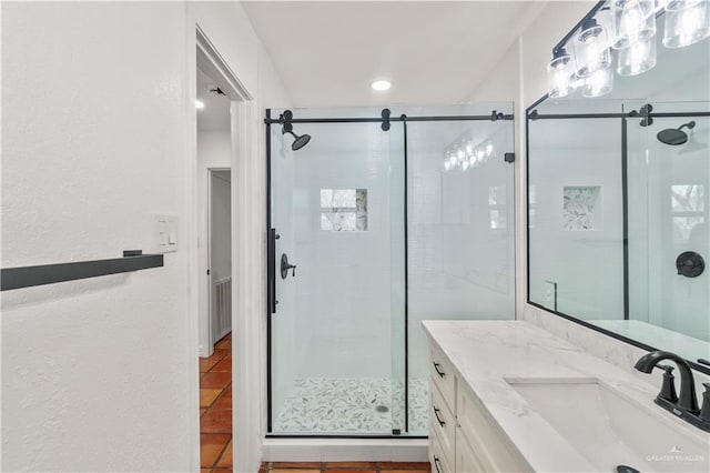 bathroom with tile patterned floors, vanity, and a shower with door