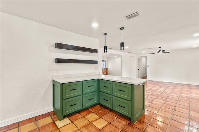 kitchen with light tile patterned flooring, green cabinetry, hanging light fixtures, kitchen peninsula, and ceiling fan