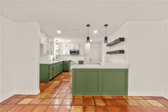 kitchen with green cabinetry, sink, white cabinets, light tile patterned floors, and kitchen peninsula