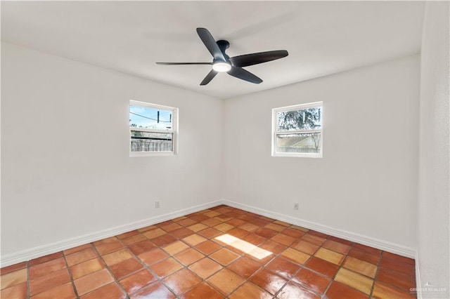 spare room featuring a healthy amount of sunlight and ceiling fan