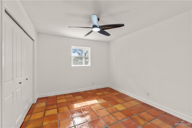 unfurnished bedroom featuring ceiling fan, tile patterned floors, and a closet