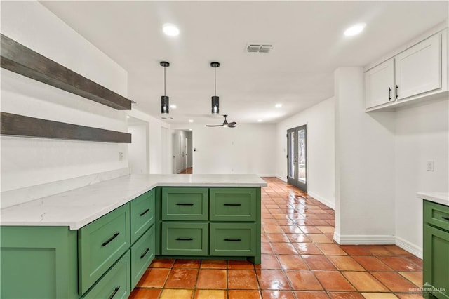 kitchen featuring white cabinetry, pendant lighting, kitchen peninsula, and green cabinetry