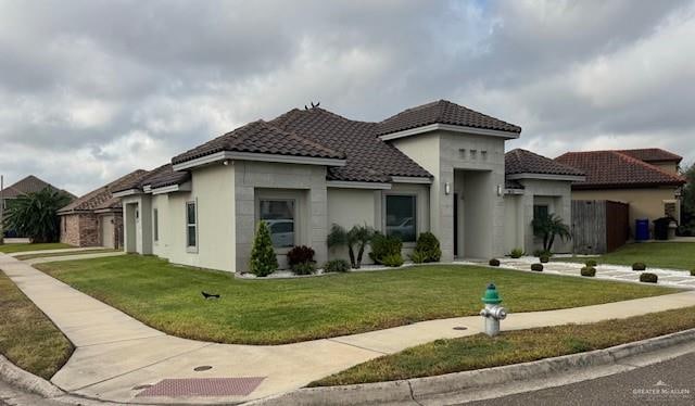 mediterranean / spanish-style home featuring a front lawn