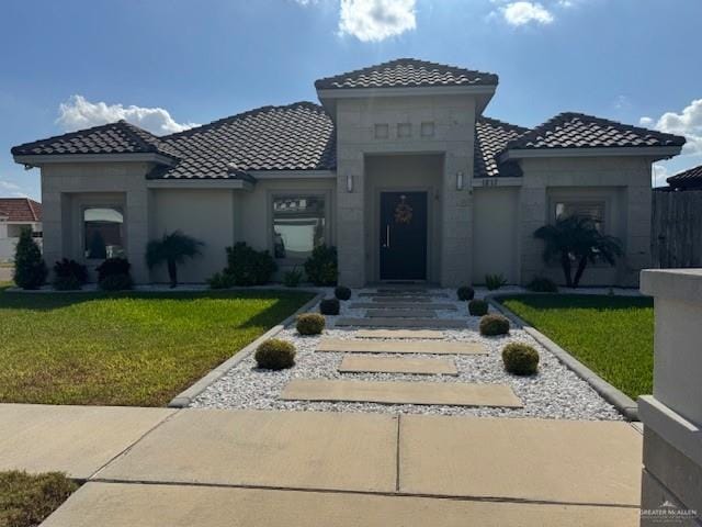 mediterranean / spanish-style home with a front yard