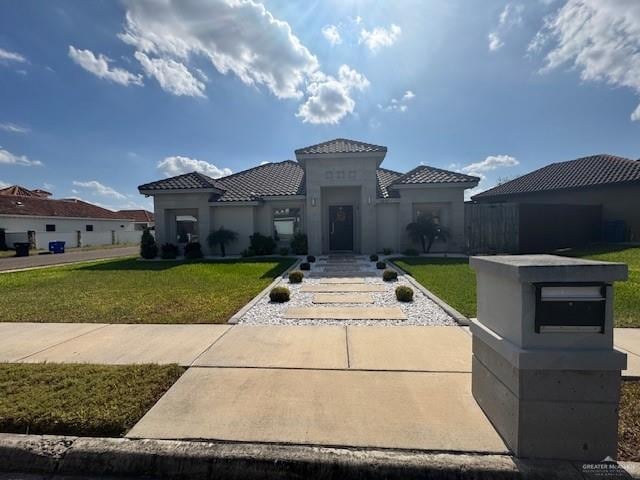 mediterranean / spanish-style house with a front lawn