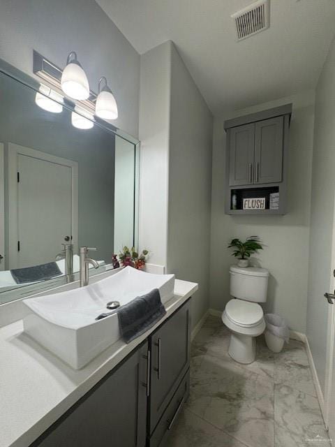 bathroom with vanity, toilet, and vaulted ceiling