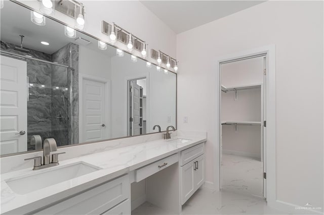 bathroom with double vanity, a marble finish shower, a sink, and marble finish floor