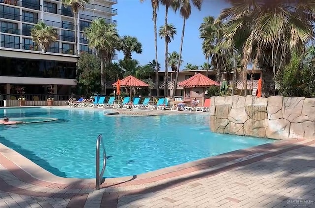 view of swimming pool with a gazebo, pool water feature, and a patio