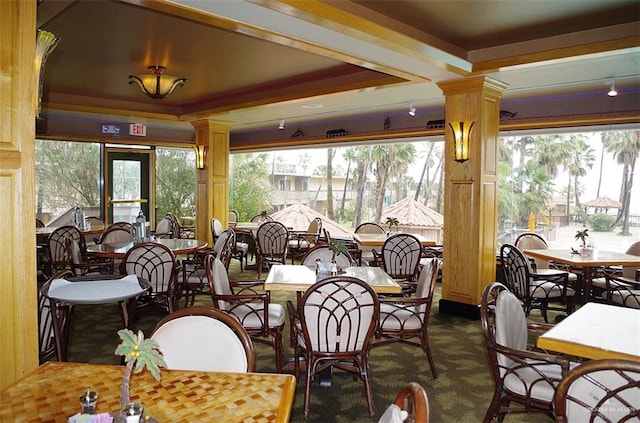 sunroom / solarium featuring decorative columns