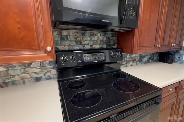 kitchen featuring backsplash and black appliances