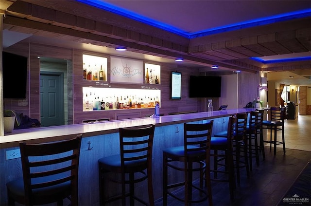 bar with hardwood / wood-style flooring