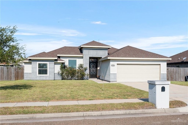 view of front of property with a garage and a front lawn