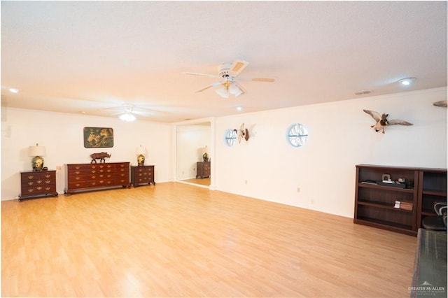 interior space featuring ceiling fan, visible vents, and wood finished floors