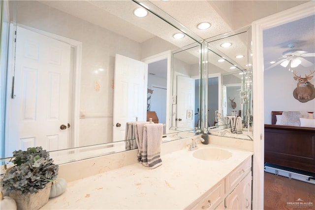 ensuite bathroom featuring recessed lighting, a ceiling fan, connected bathroom, and vanity