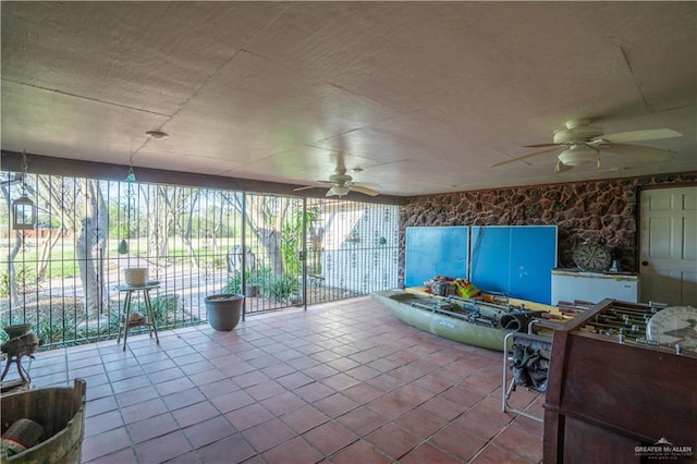 sunroom featuring ceiling fan