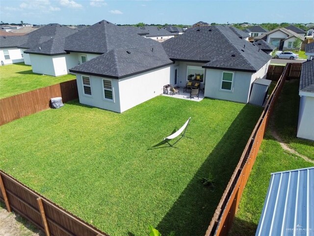 1313 W Dawes Ave W, Alton, TX 78573 - rear view of property featuring roof with shingles, a residential view, stucco siding, and a patio area