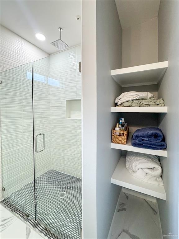 1313 W Dawes Ave W, Alton, TX 78573 - bathroom featuring a stall shower and marble finish floors
