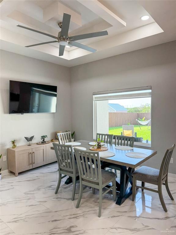 1313 W Dawes Ave W, Alton, TX 78573 - dining room with light marble finish flooring, ceiling fan, recessed lighting, baseboards, and a raised ceiling