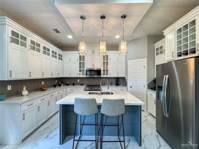 1313 W Dawes Ave W, Alton, TX 78573 - kitchen featuring appliances with stainless steel finishes, light marble finish flooring, recessed lighting, a sink, and an island with sink