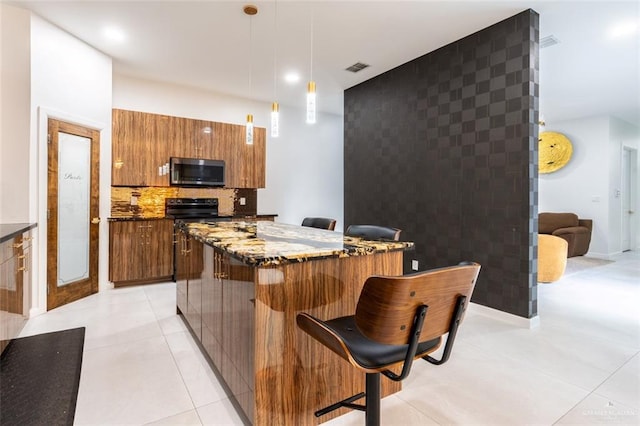 4225 Wichita Ave, Mcallen, TX 78503 - kitchen featuring stainless steel microwave, brown cabinetry, a breakfast bar area, modern cabinets, and a kitchen island