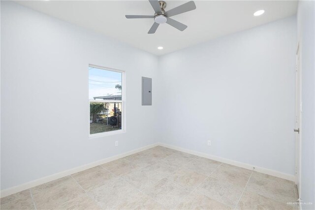 spare room featuring a ceiling fan, recessed lighting, electric panel, and baseboards