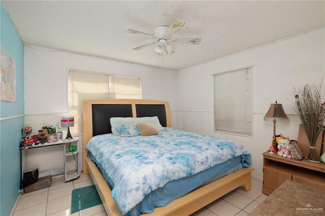 bedroom with a ceiling fan and light tile patterned flooring