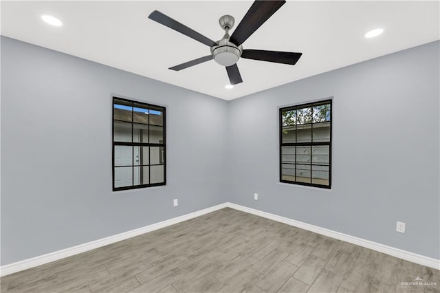 unfurnished room with ceiling fan and light hardwood / wood-style floors