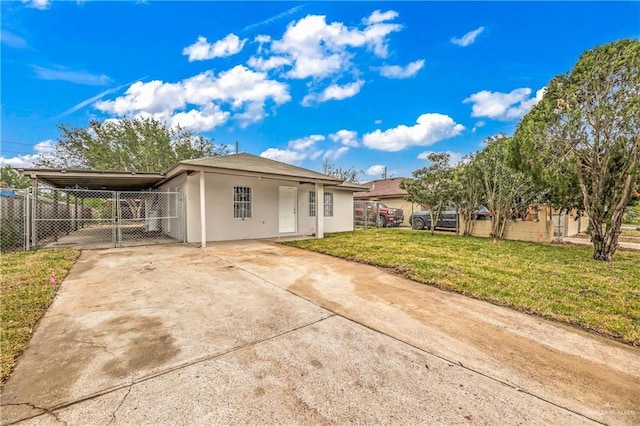 view of front facade with a carport and a front lawn