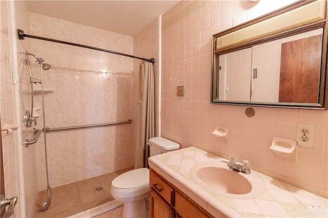 full bath featuring vanity, tile walls, toilet, and a stall shower