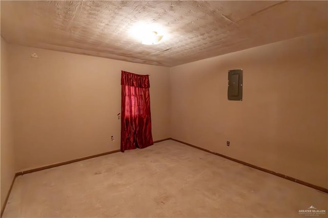 spare room with electric panel and baseboards