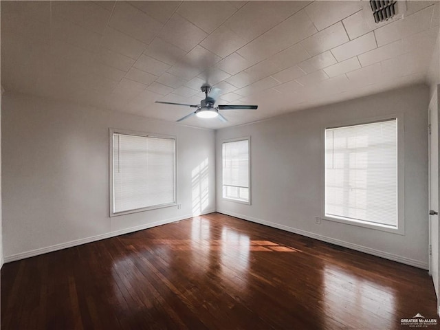 unfurnished room with ceiling fan and dark hardwood / wood-style flooring