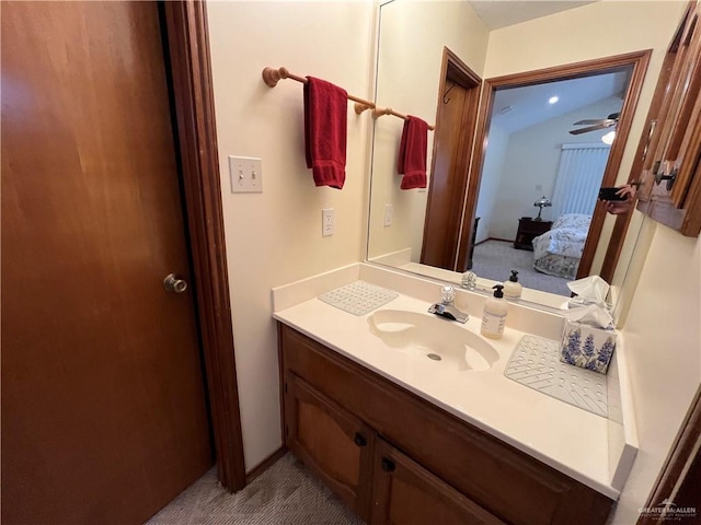 ensuite bathroom with connected bathroom and vanity