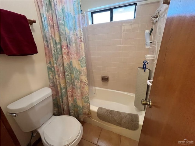 full bathroom featuring shower / bath combo, toilet, and tile patterned floors