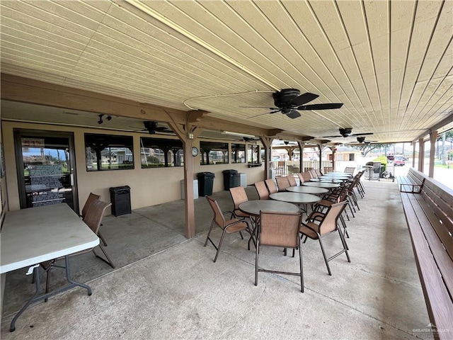 view of patio with outdoor dining space and a ceiling fan